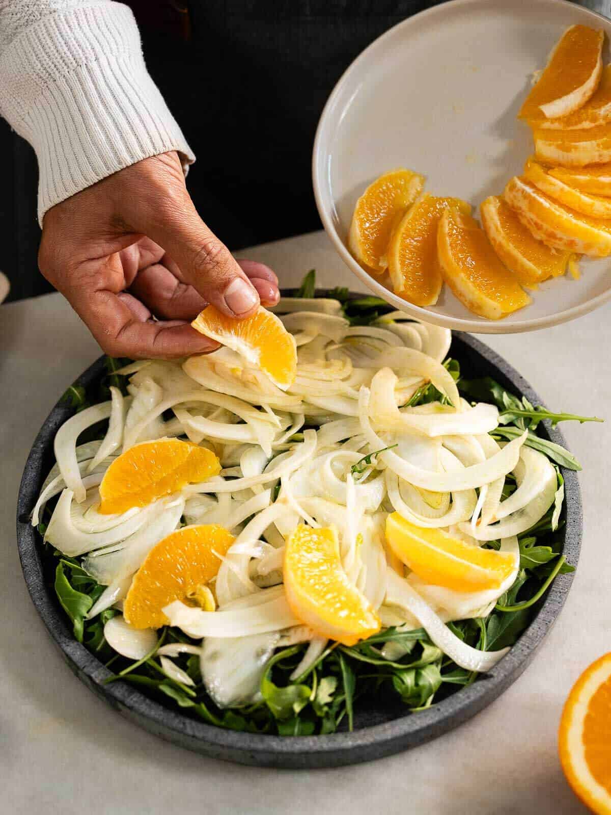 agregando naranja a la ensalada.