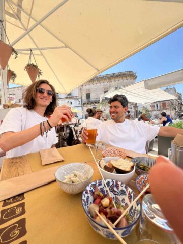 Persona disfrutando de una comida en una terraza de Ostuni.