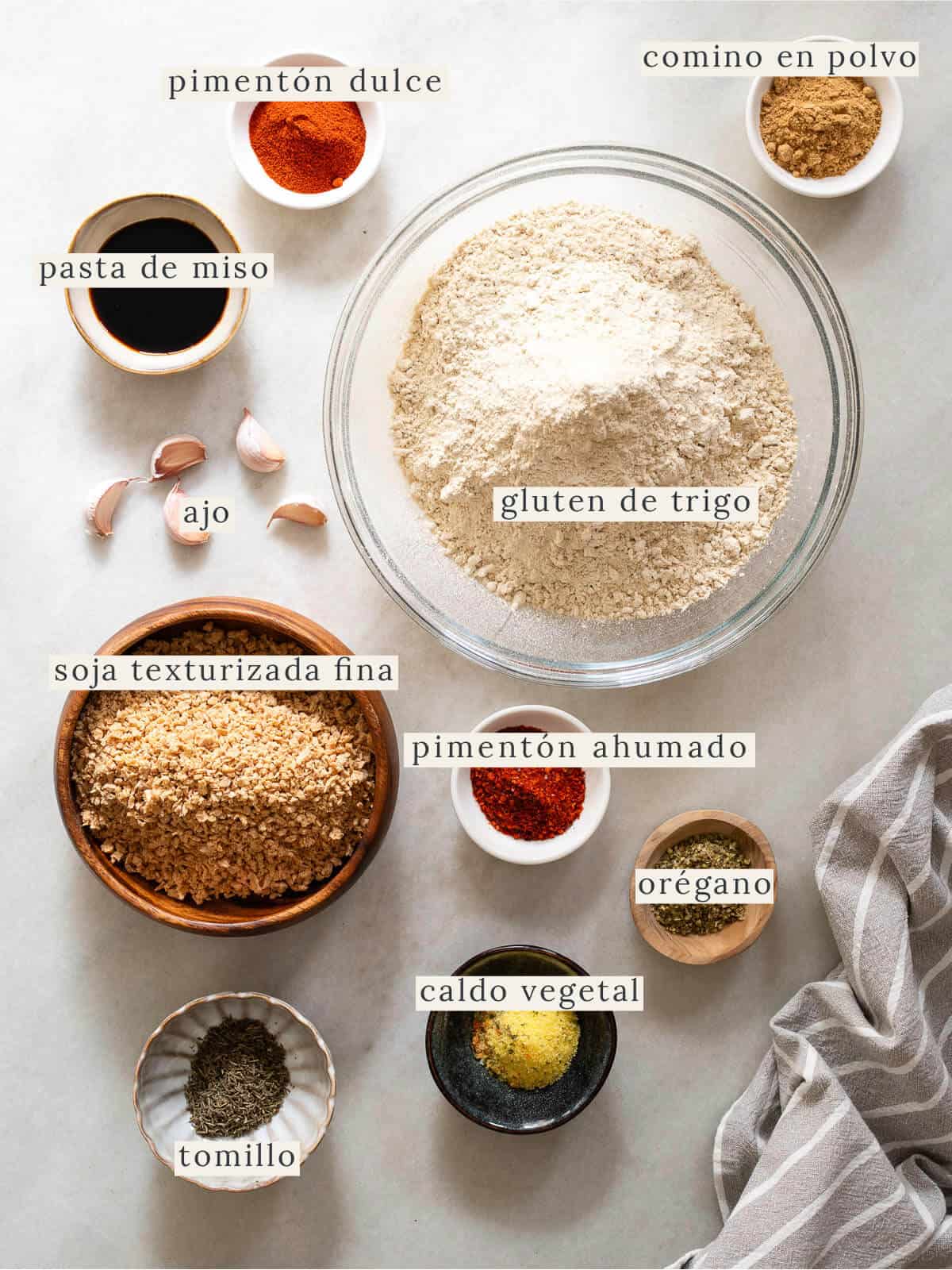 Ingredientes principales para preparar seitán casero: gluten de trigo, soya texturizada fina, ajo, caldo vegetal, pasta de miso y especias como comino, tomillo, orégano y pimentón ahumado. Receta vegana rica en proteína vegetal.